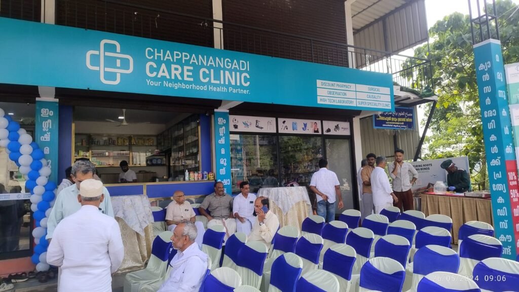 “Exterior view of Chappanangadi Care Clinic with people gathered for an event.”