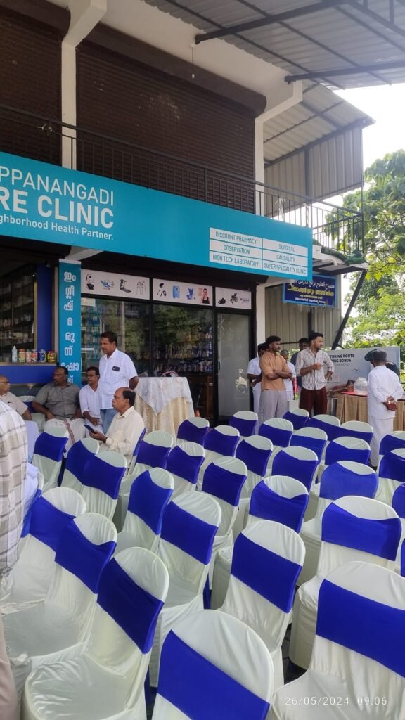 “Exterior view of Chappanangadi Care Clinic with people gathered for an event.”