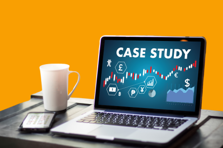 financial-case-study-presentation-on-laptop A laptop displaying colorful graphics with the words “CASE STUDY” and various financial symbols, alongside a white mug and a smartphone.